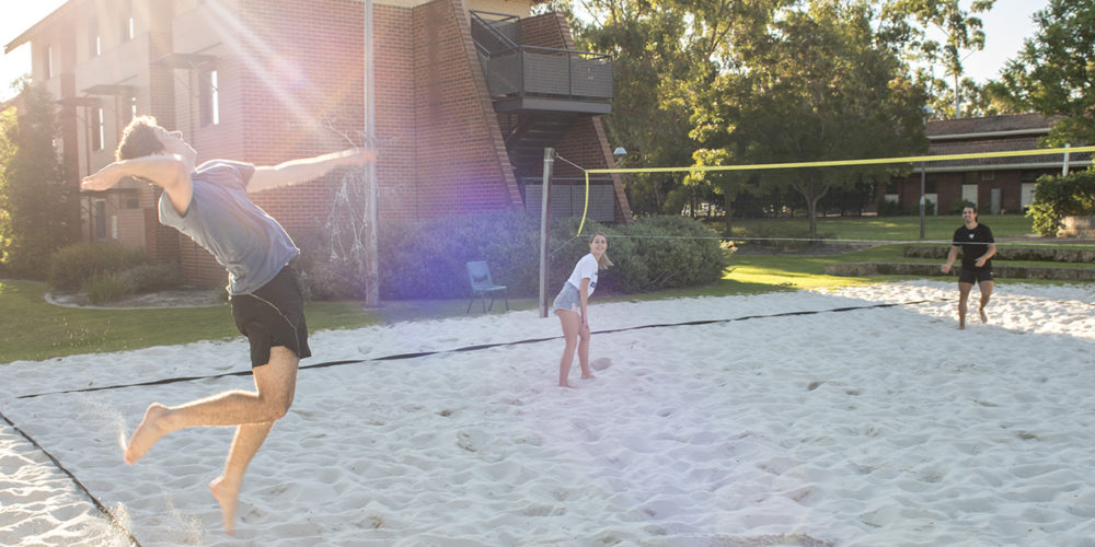 A group of students playing volleyball at Curtin accommodation