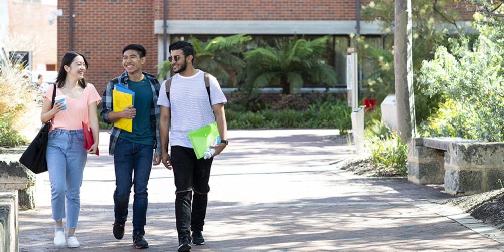 Group of students walking on Bentley campus.