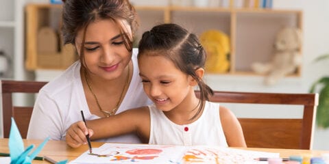 Kids smiling while painting